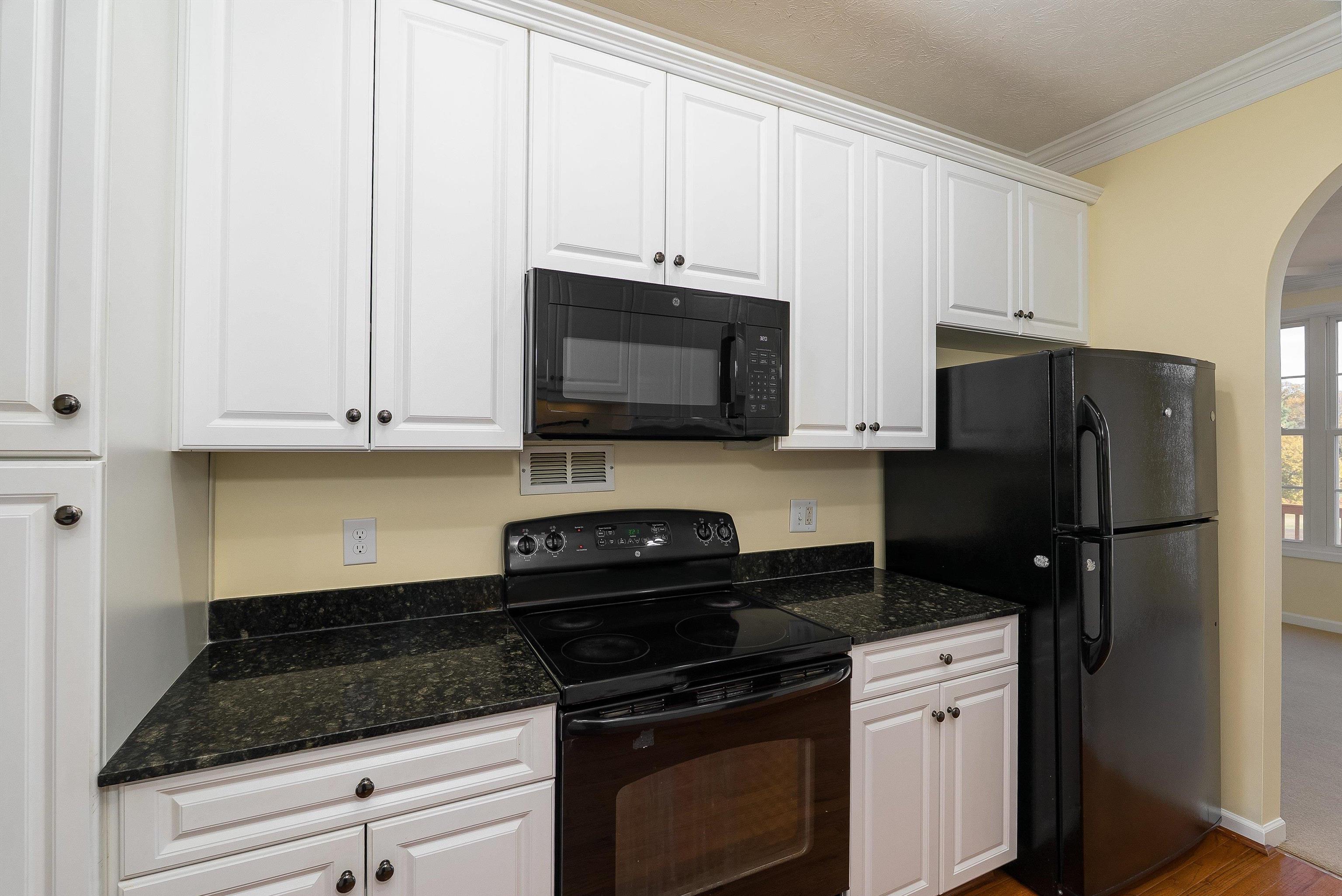 1439 Flowing Spring Lane Harrisonburg, VA 22801 - Photo 15 of 44 a kitchen with granite countertop white cabinets and stainless steel appliances