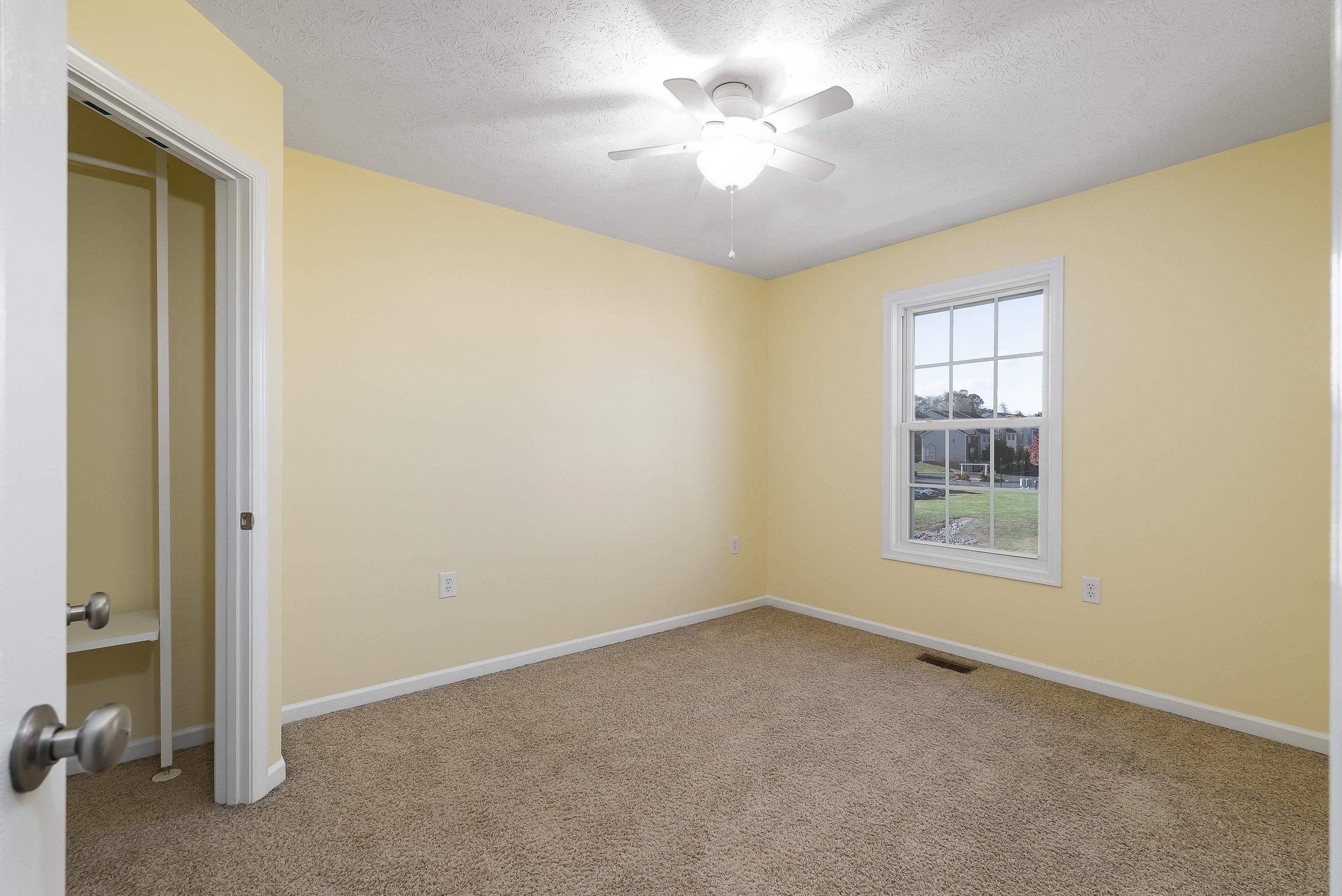 1439 Flowing Spring Lane Harrisonburg, VA 22801 - Photo 27 of 44 an empty room with a chandelier fan and windows