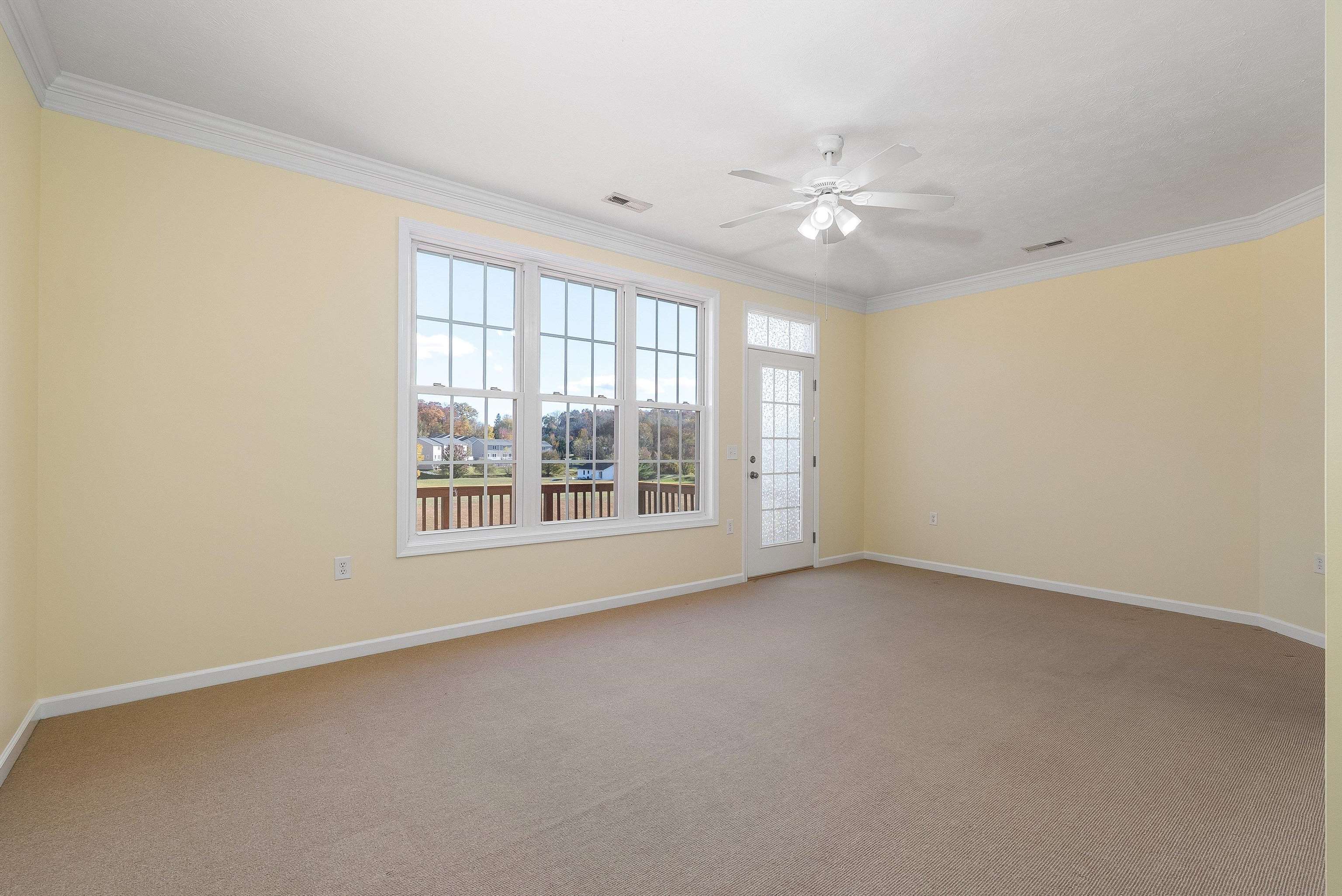 1439 Flowing Spring Lane Harrisonburg, VA 22801 - Photo 10 of 44 an empty room with chandelier fan and windows