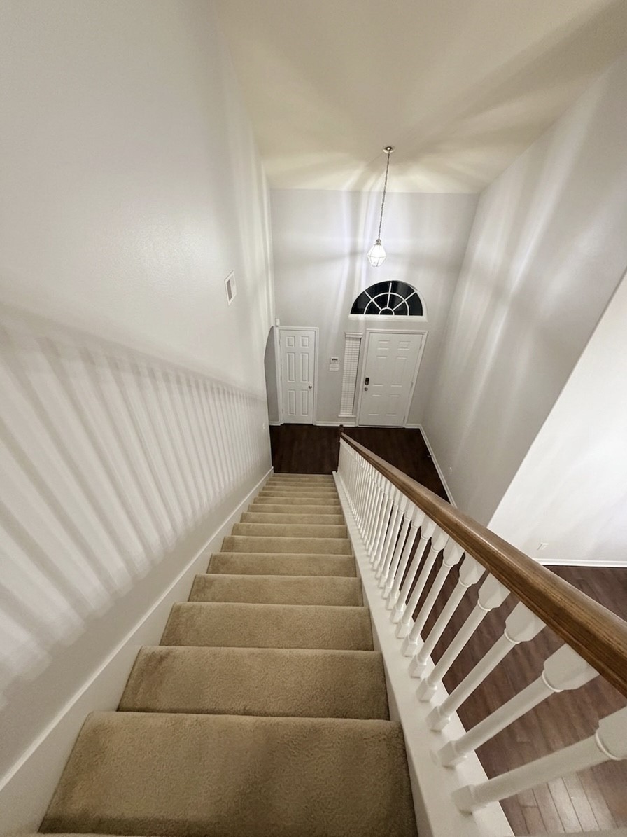 9908 Climbing Tree Street Conroe, TX 77385 - Photo 15 of 26 a hallway with a staircase