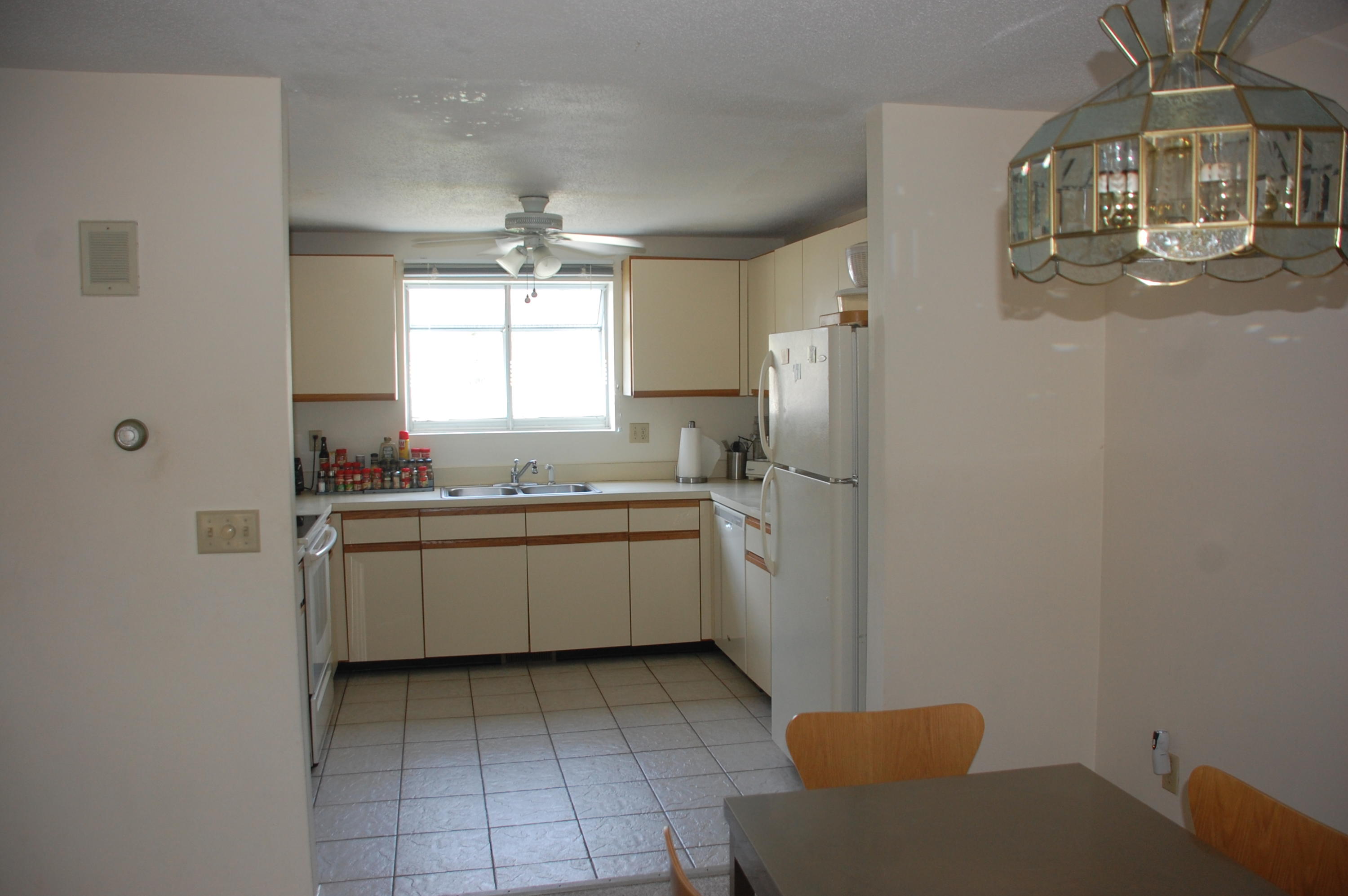 156 Shellback Way, Unit X156 Mashpee, MA 02649 - Photo 2 of 7 a kitchen with sink cabinets and window