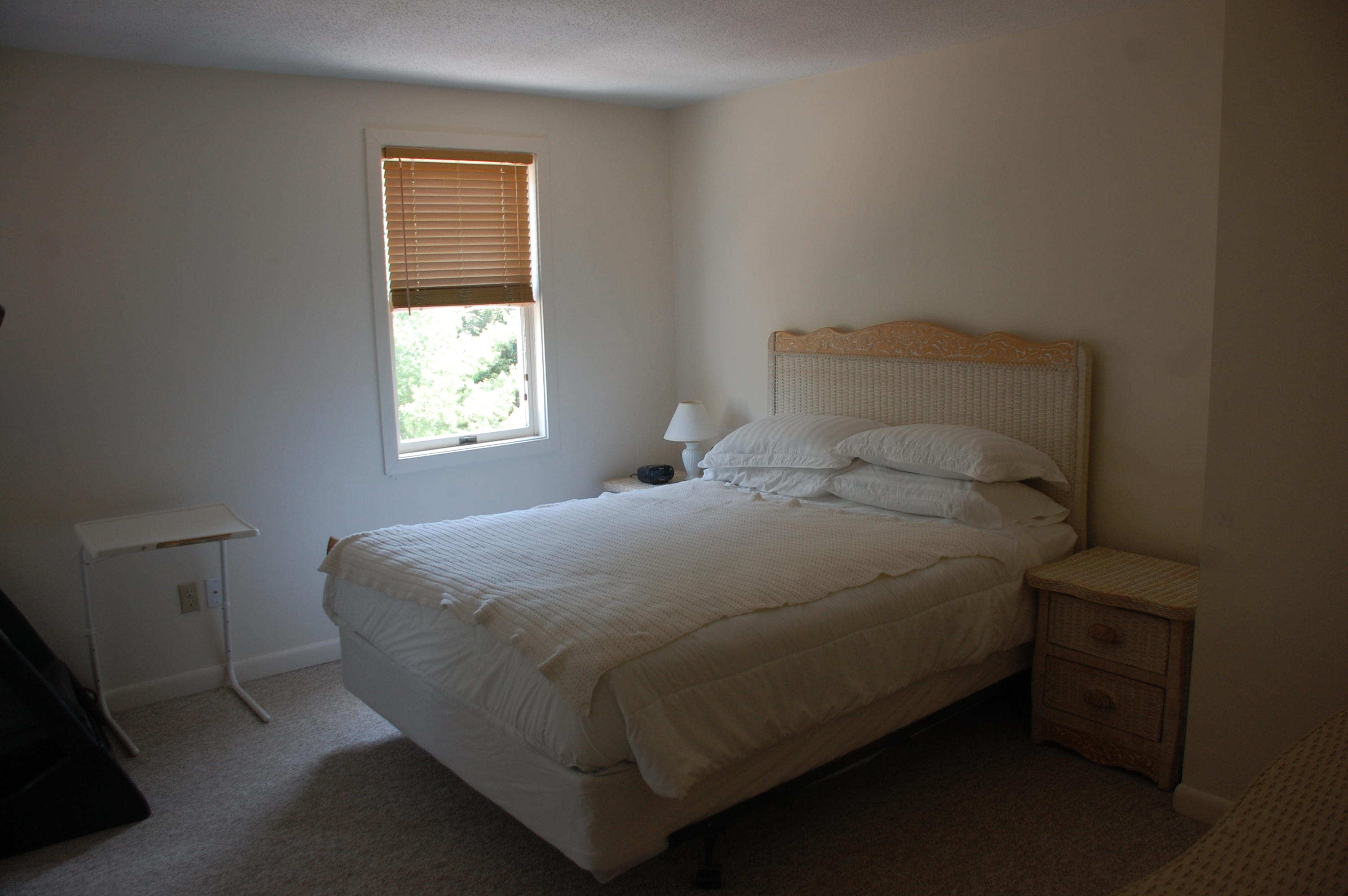 156 Shellback Way, Unit X156 Mashpee, MA 02649 - Photo 6 of 7 a bed sitting in a bedroom next to a window