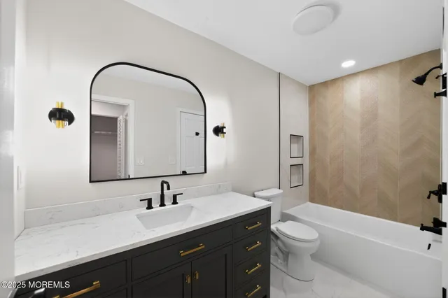 a bathroom with a sink a toilet and a mirror