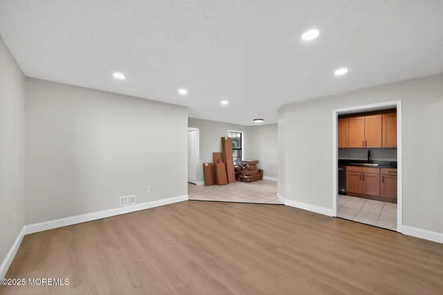 a view of a room with wooden floor