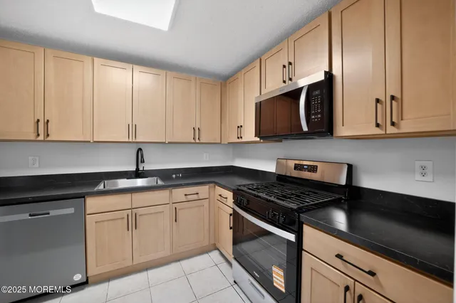 a kitchen with stainless steel appliances granite countertop white cabinets granite counter tops and a wooden cabinets