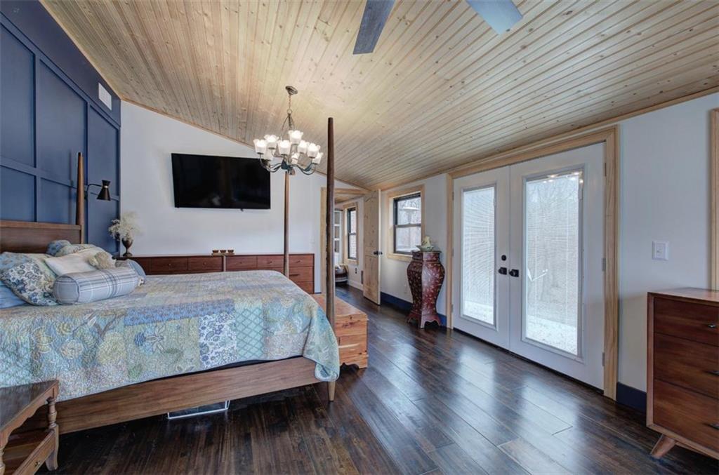 675 McGee Bend Road Southwest Cave Spring, GA 30124 - Photo 19 of 71 a spacious bedroom with a bed and a flat screen tv
