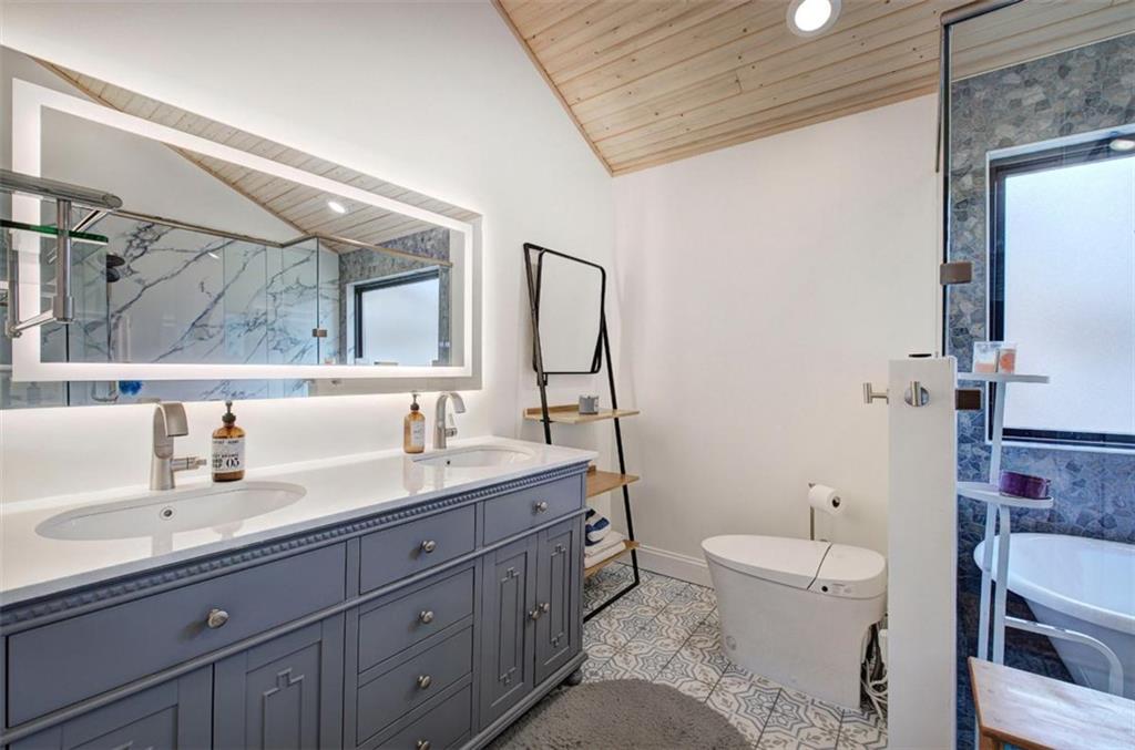 675 McGee Bend Road Southwest Cave Spring, GA 30124 - Photo 24 of 71 a bathroom with a granite countertop sink mirror vanity and toilet