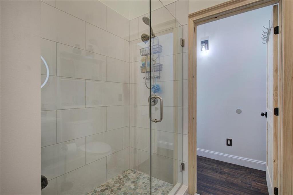 675 McGee Bend Road Southwest Cave Spring, GA 30124 - Photo 26 of 71 a bathroom with a glass shower door