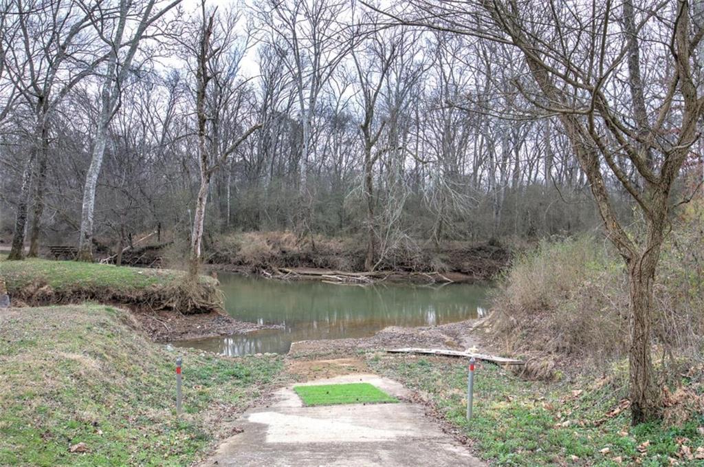 675 McGee Bend Road Southwest Cave Spring, GA 30124 - Photo 39 of 71 a view of a lake with a yard and large trees