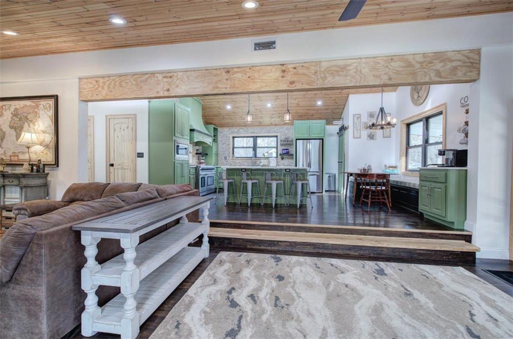 675 McGee Bend Road Southwest Cave Spring, GA 30124 - Photo 5 of 71 a living room with a bed and glass windows