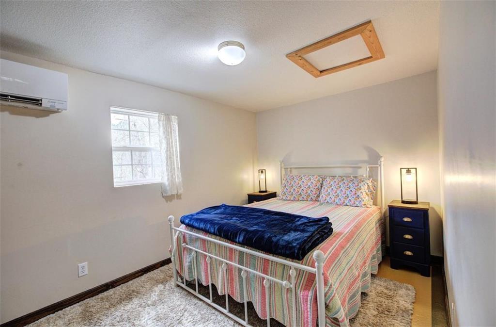 675 McGee Bend Road Southwest Cave Spring, GA 30124 - Photo 57 of 71 a bedroom with a bed and a lamp