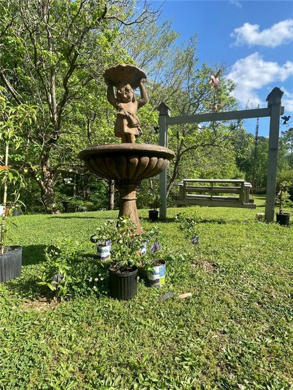 675 McGee Bend Road Southwest Cave Spring, GA 30124 - Photo 68 of 71 a view of a garden with a bench