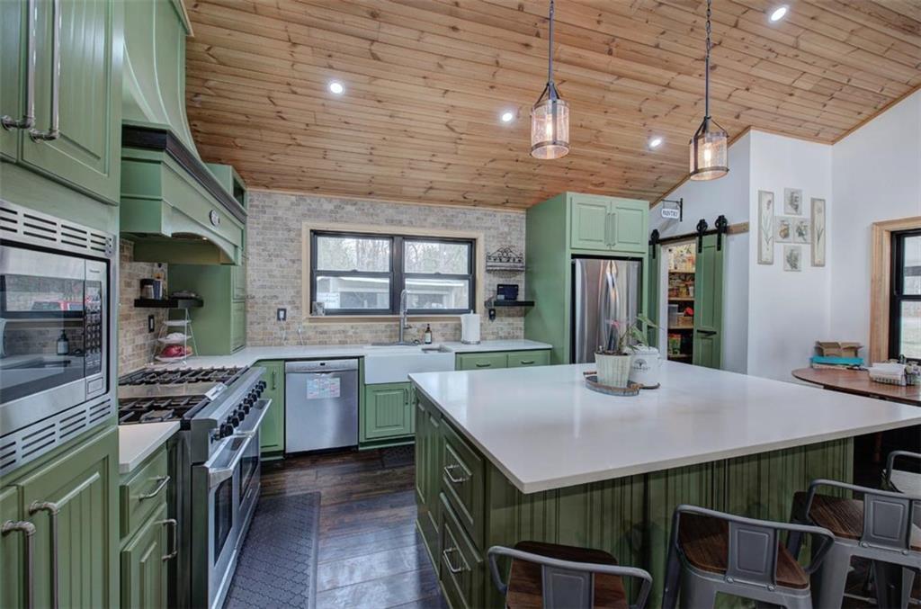 675 McGee Bend Road Southwest Cave Spring, GA 30124 - Photo 8 of 71 a kitchen with kitchen island a sink table and chairs