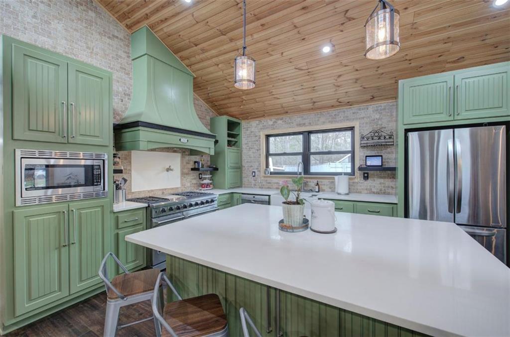 675 McGee Bend Road Southwest Cave Spring, GA 30124 - Photo 9 of 71 a kitchen with a table chairs and microwave
