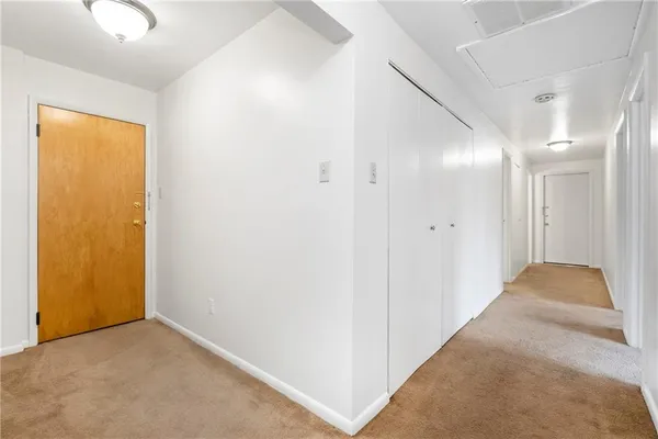 an empty room with a empty space and windows