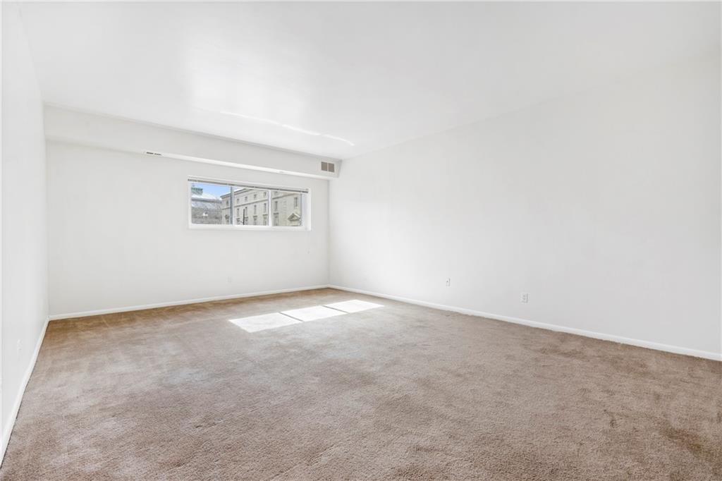 307 South Dithridge Street, Unit 11 Pittsburgh, PA 15213 - Photo 16 of 33 an empty room with a window