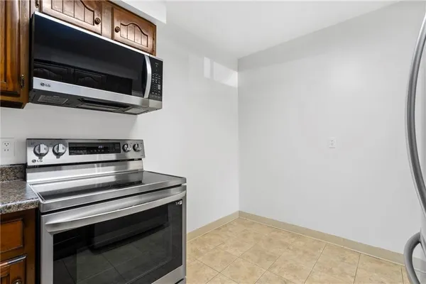 a kitchen with stainless steel appliances wooden cabinets and a stove top oven