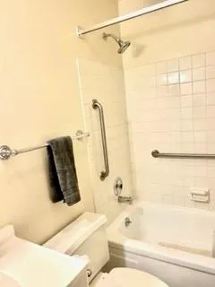 a bathroom with a sink a toilet and mirror