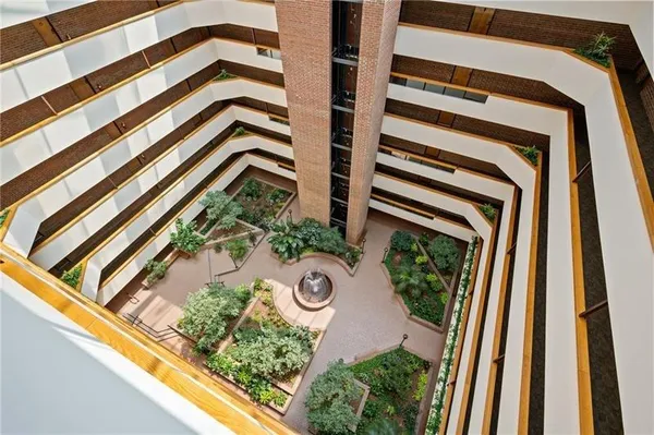 a view of a patio with a table and chairs and potted plants