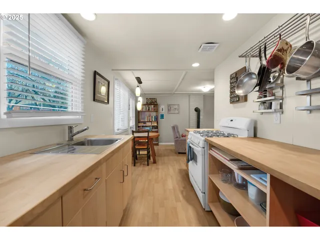 a kitchen with a sink a stove and chairs