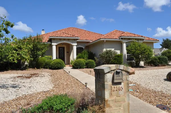 a front view of a house with yard