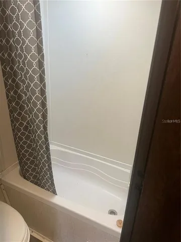a bathroom with a bathtub and shower