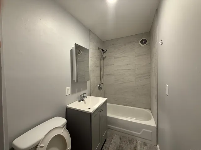a bathroom with a sink toilet and shower