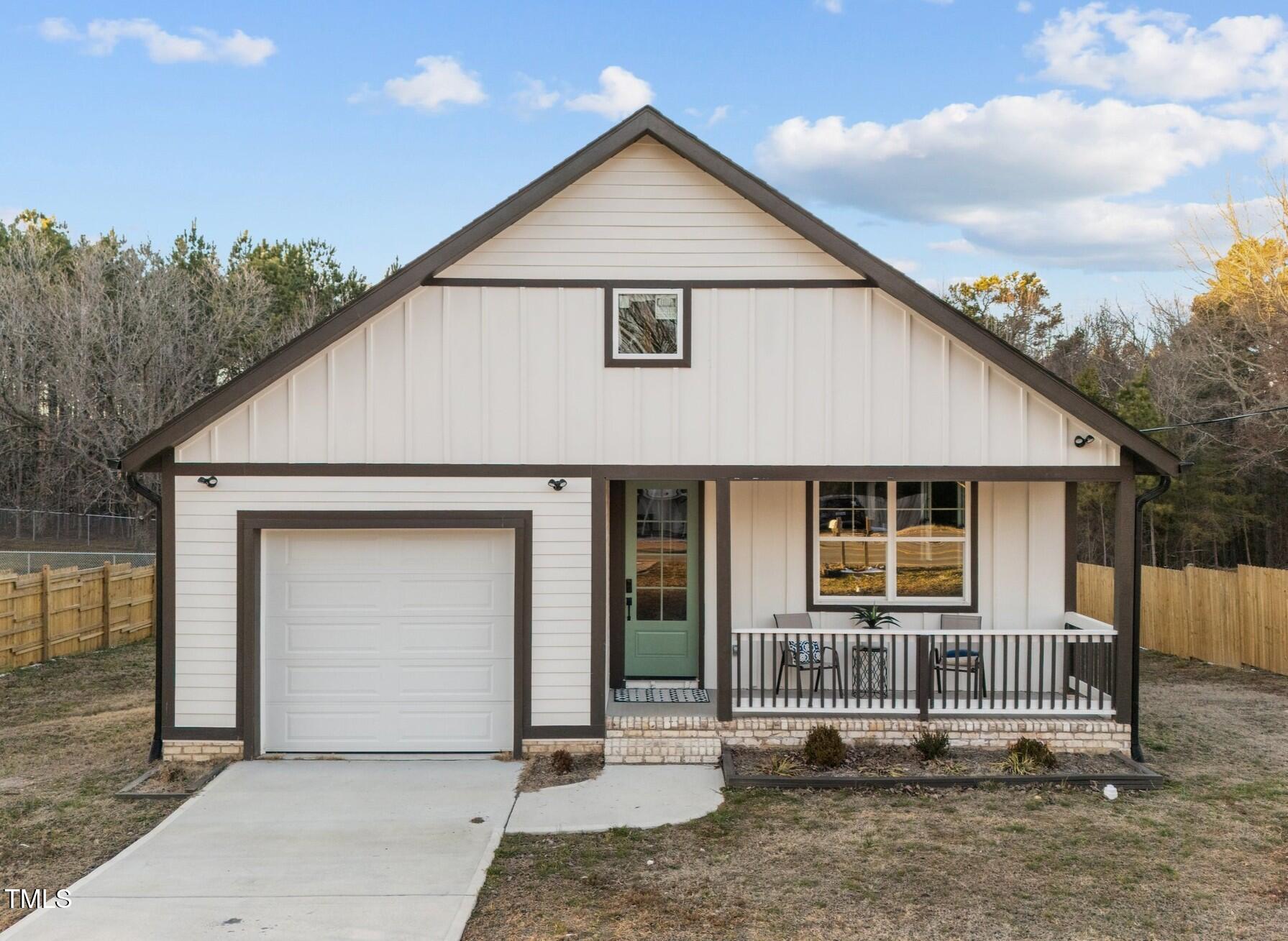 1101 Ridge Road Roxboro, NC 27573 - Photo 1 of 44 a view of a house with wooden fence and large windows