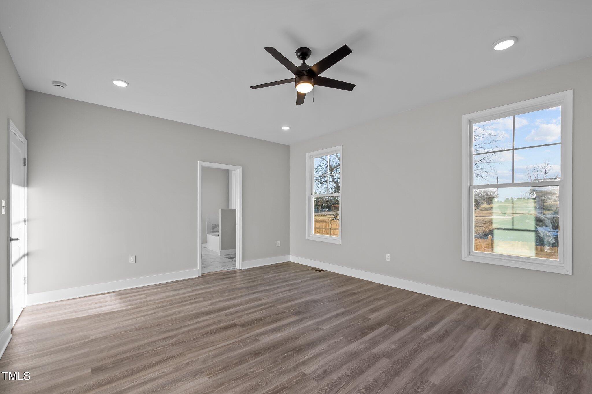 1101 Ridge Road Roxboro, NC 27573 - Photo 15 of 44 a view of an empty room with wooden floor and a window