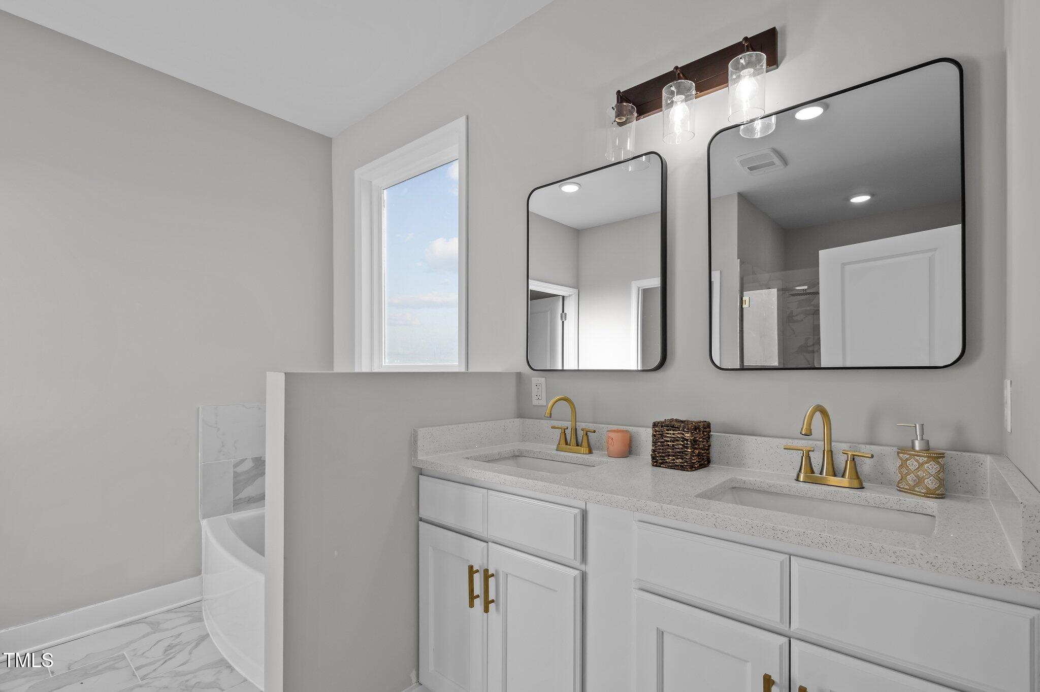 1101 Ridge Road Roxboro, NC 27573 - Photo 16 of 44 a bathroom with a sink a vanity and a mirror