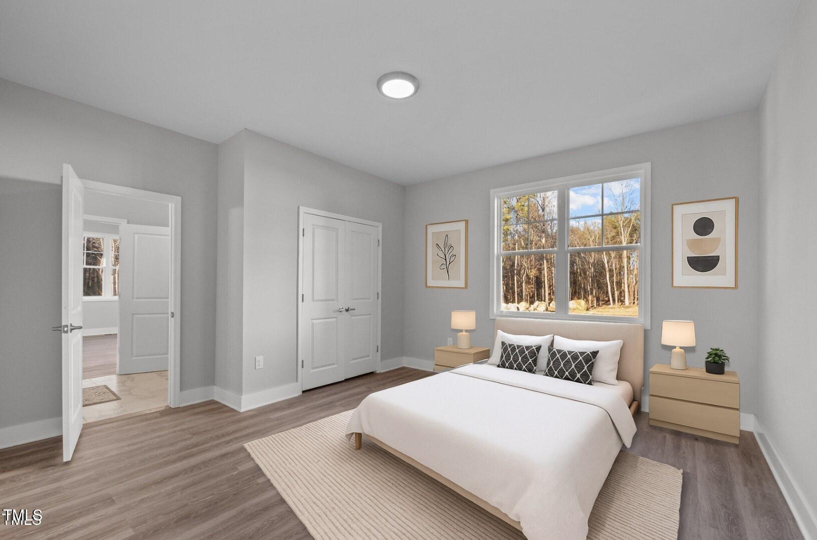 1101 Ridge Road Roxboro, NC 27573 - Photo 21 of 44 a bedroom with a large bed and wooden floor