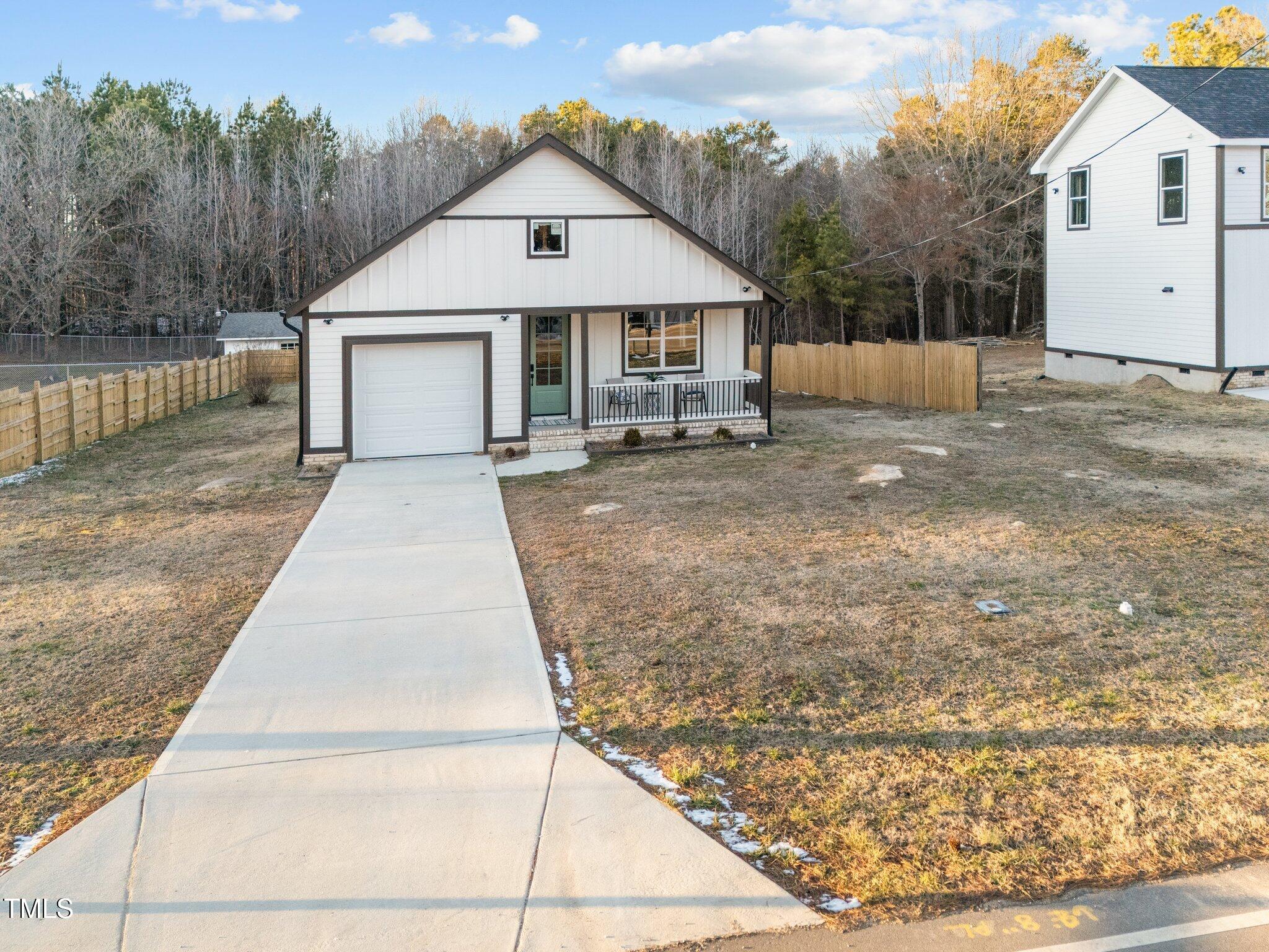 1101 Ridge Road Roxboro, NC 27573 - Photo 43 of 44 a front view of a house with a yard and garage