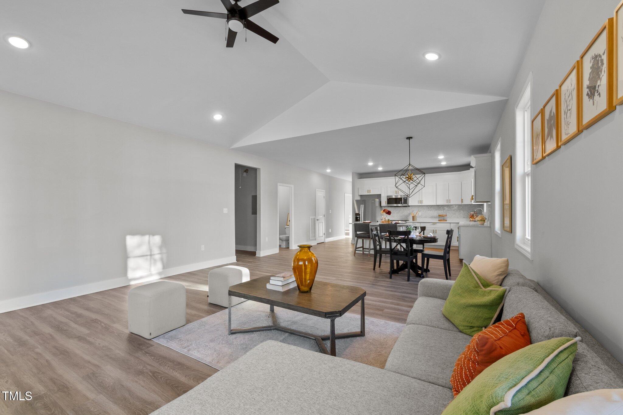 1101 Ridge Road Roxboro, NC 27573 - Photo 6 of 44 a living room with furniture and a dining table with wooden floor