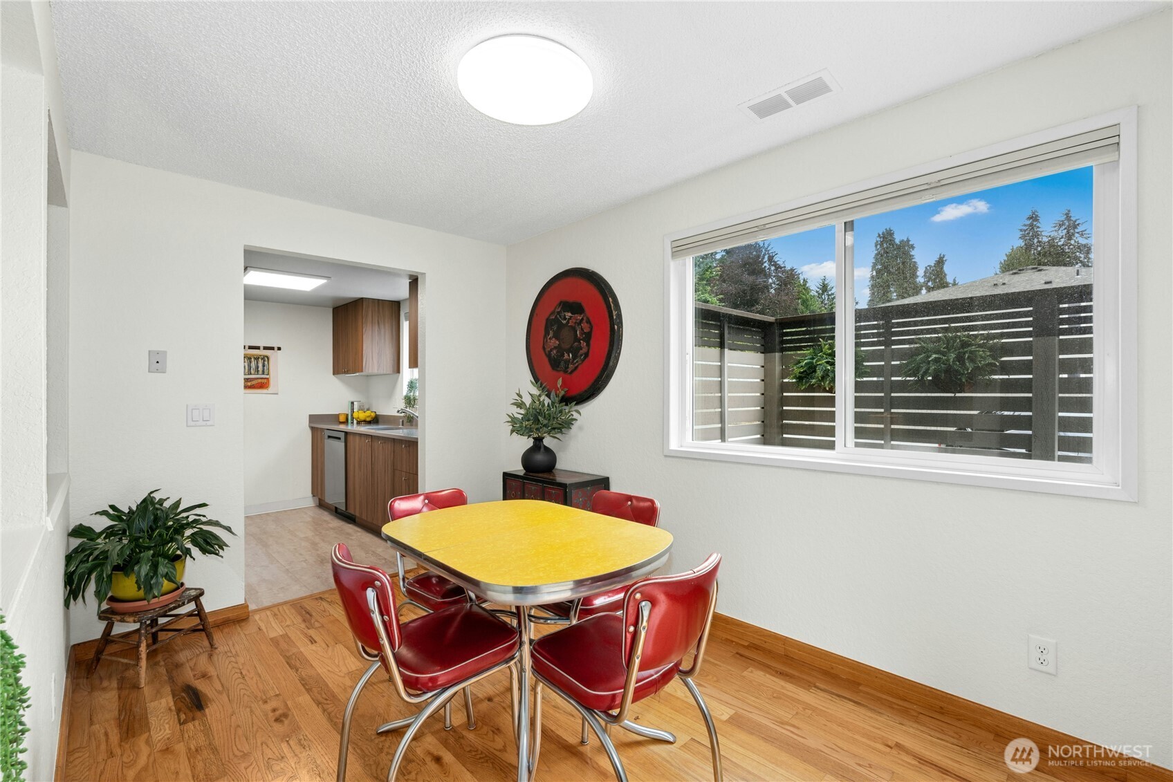 9523 Northeast 180th Street, Unit A102 Bothell, WA 98011 - Photo 10 of 29 a view of a dining room with furniture window and wooden floor