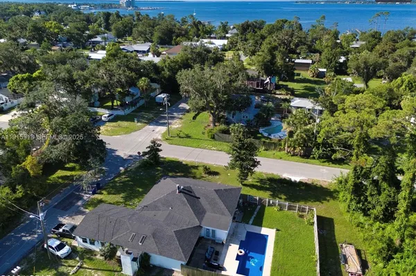 an aerial view of residential houses with outdoor space and street view