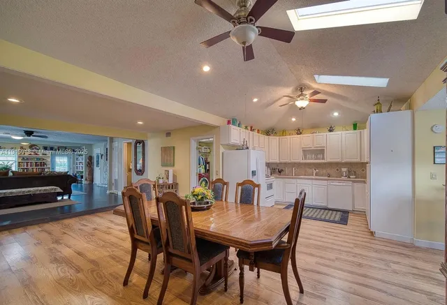 a dining room with furniture and wooden floor