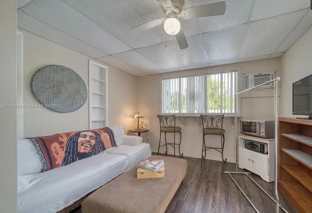 a living room with furniture a rug and a large window