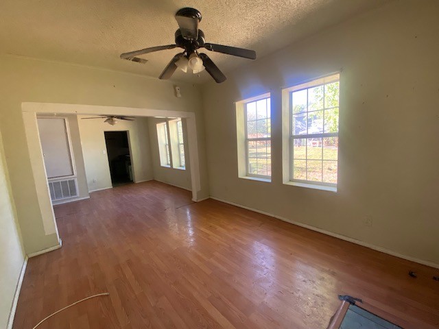 523 South Rio Grande Street Lockhart, TX 78644 - Photo 5 of 16 a view of empty room with wooden floor and fan