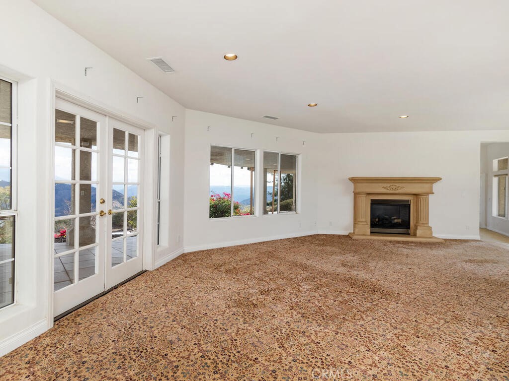 6455 Rainbow Heights Road Fallbrook, CA 92028 - Photo 12 of 63 a view of an empty room with a fireplace and a window