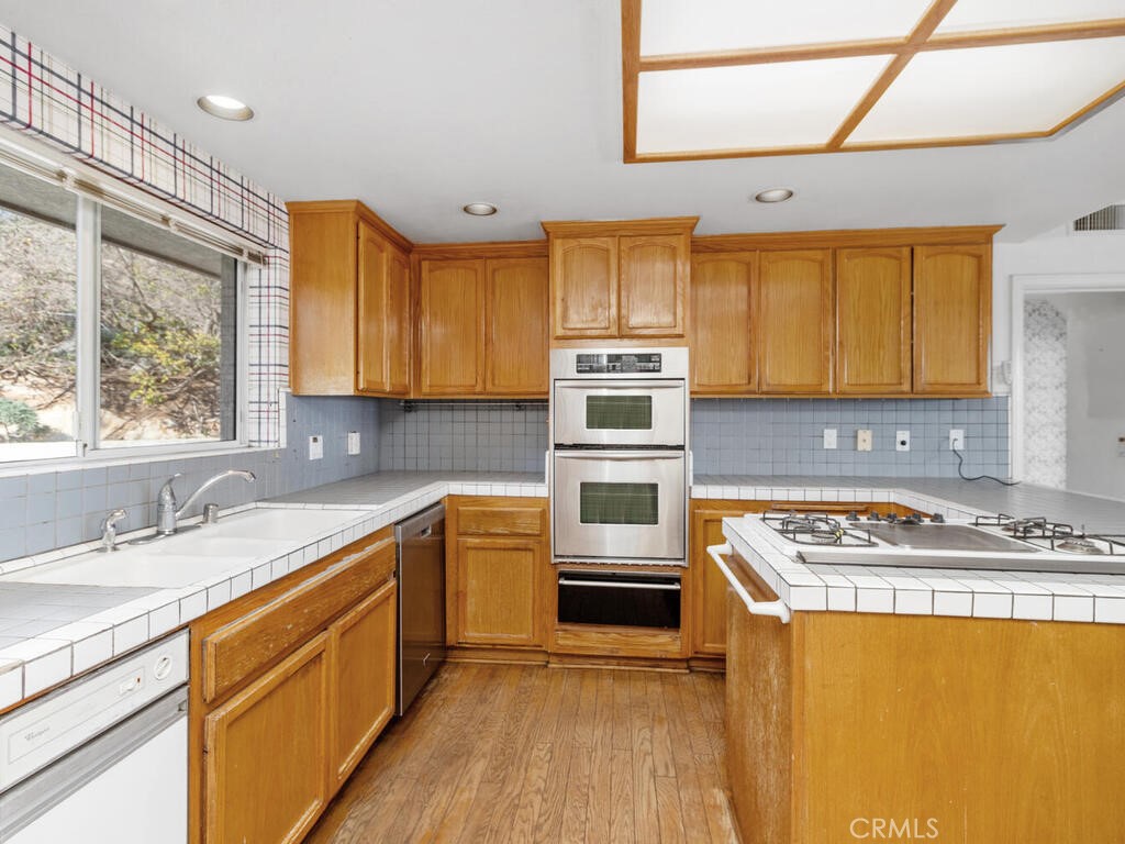 6455 Rainbow Heights Road Fallbrook, CA 92028 - Photo 18 of 63 a kitchen with stainless steel appliances granite countertop a sink stove and refrigerator