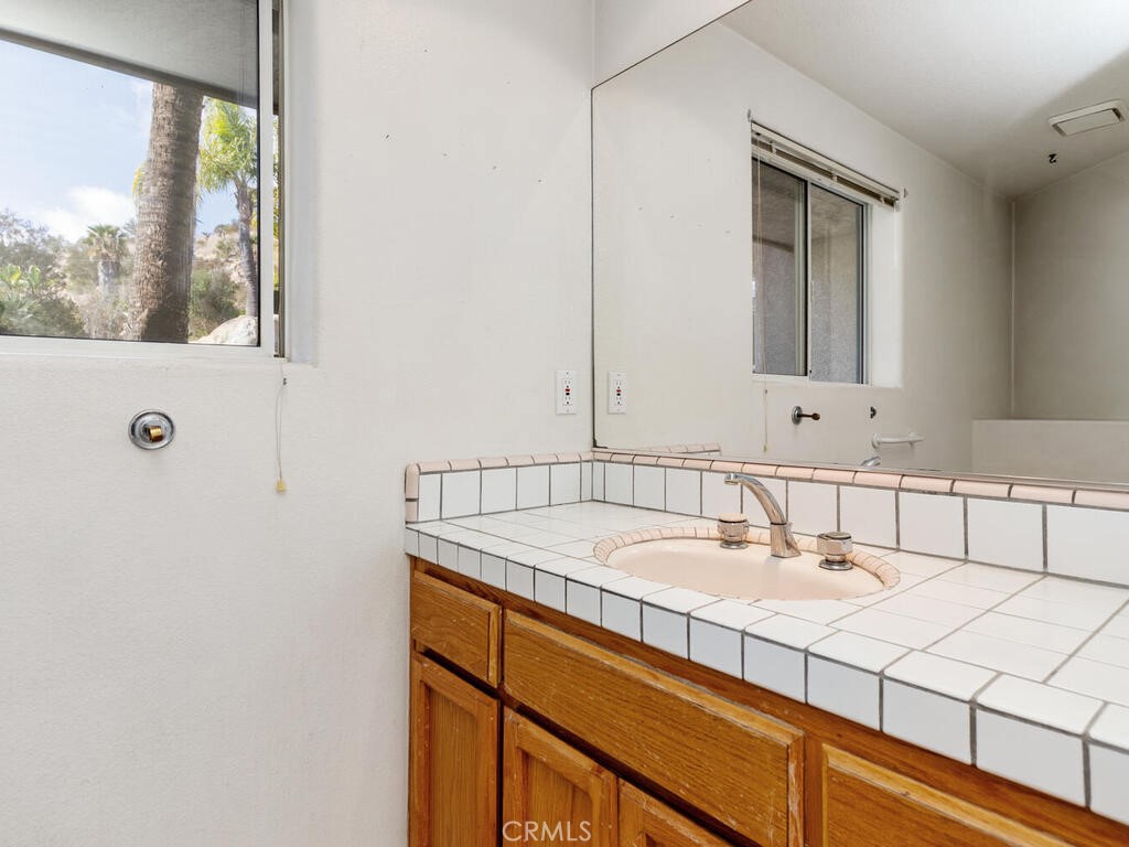 6455 Rainbow Heights Road Fallbrook, CA 92028 - Photo 23 of 63 a bathroom with a sink and a mirror