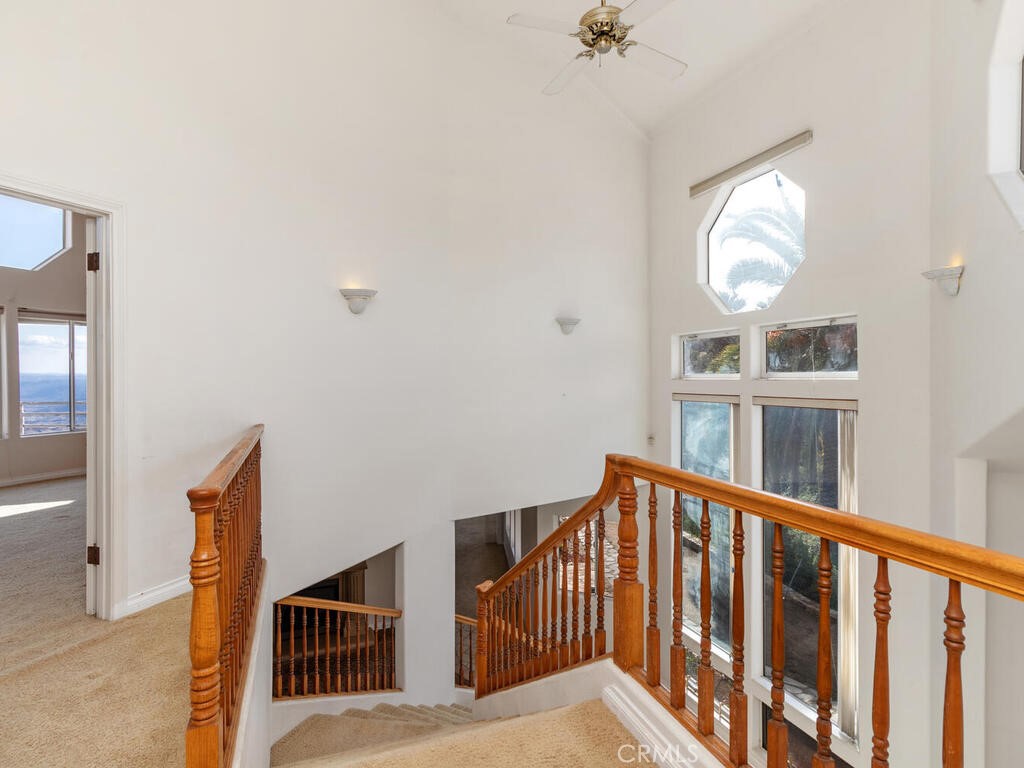 6455 Rainbow Heights Road Fallbrook, CA 92028 - Photo 29 of 63 a view of staircase with railing and a chandelier
