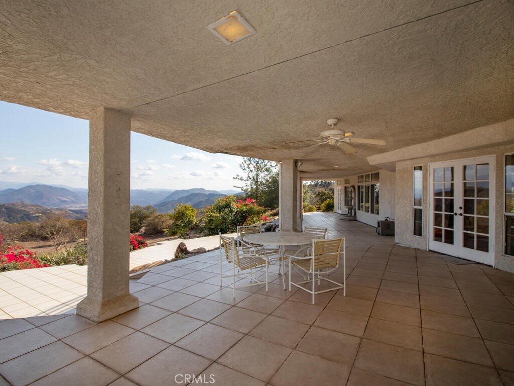 6455 Rainbow Heights Road Fallbrook, CA 92028 - Photo 41 of 63 a view of a patio with a dining table and chairs