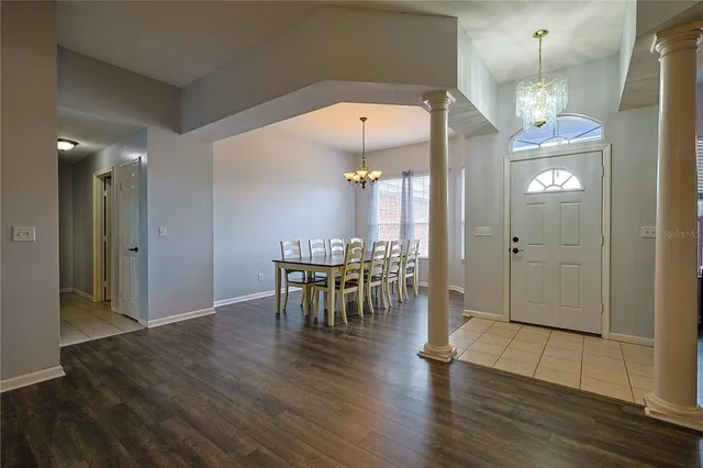 a view of a dining room with furniture and wooden floor