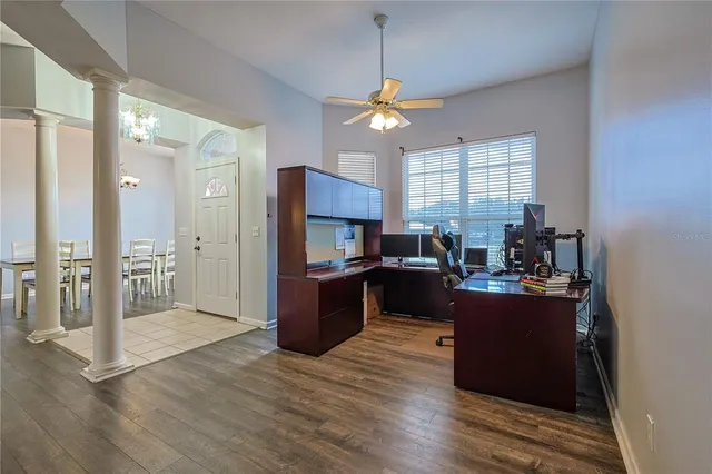 a view of kitchen with kitchen island wooden floor center island and stainless steel appliances