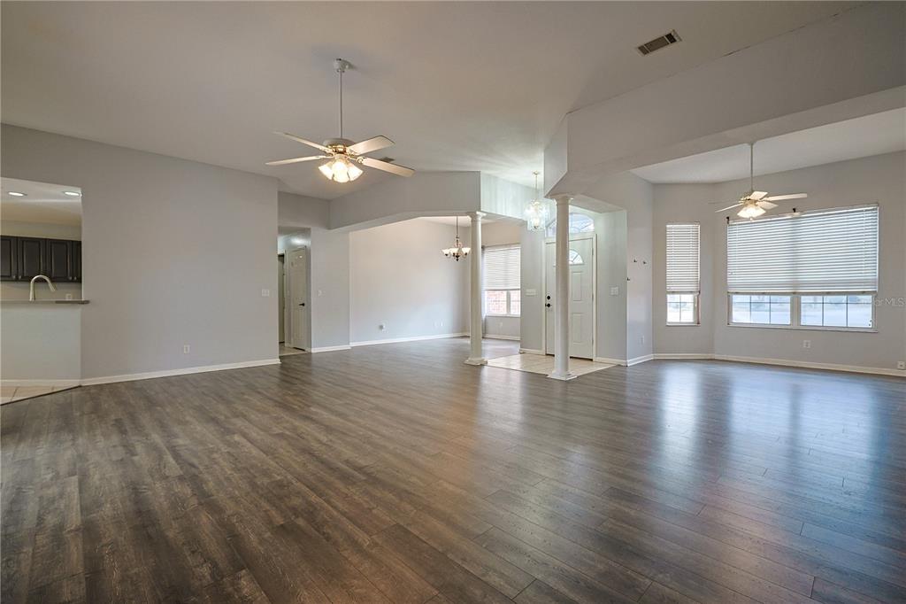 166 Southwest Hancock Court Lake City, FL 32024 - Photo 14 of 46 wooden floor in an empty room with a window