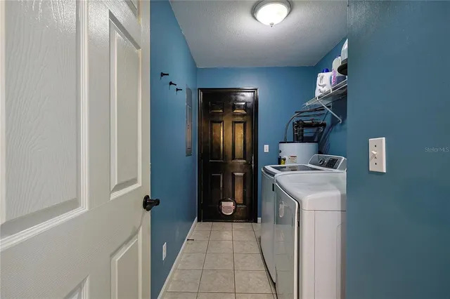 a kitchen with a refrigerator and cabinets