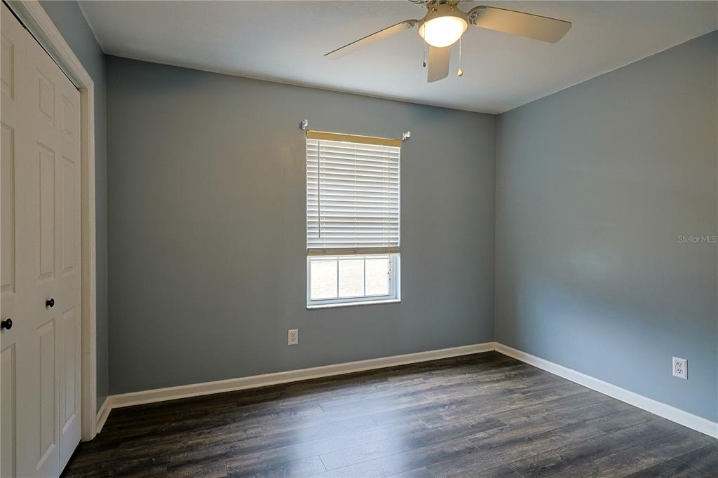 166 Southwest Hancock Court Lake City, FL 32024 - Photo 22 of 46 an empty room with wooden floor and windows