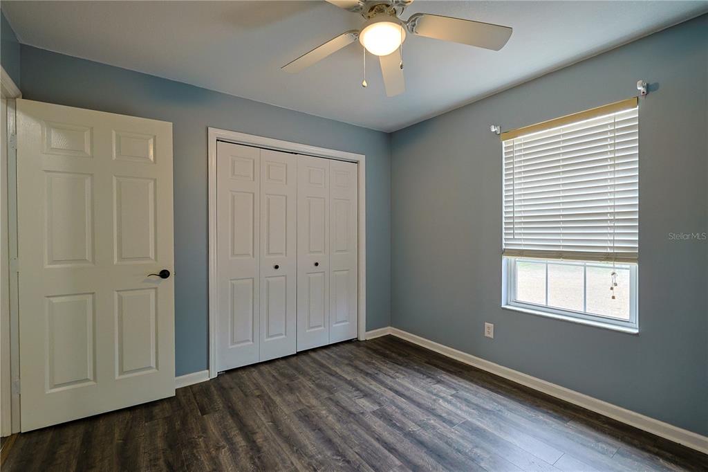 166 Southwest Hancock Court Lake City, FL 32024 - Photo 23 of 46 a view of an empty room with wooden floor and a window
