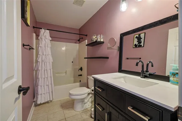 a bathroom with a sink a toilet a mirror and shower